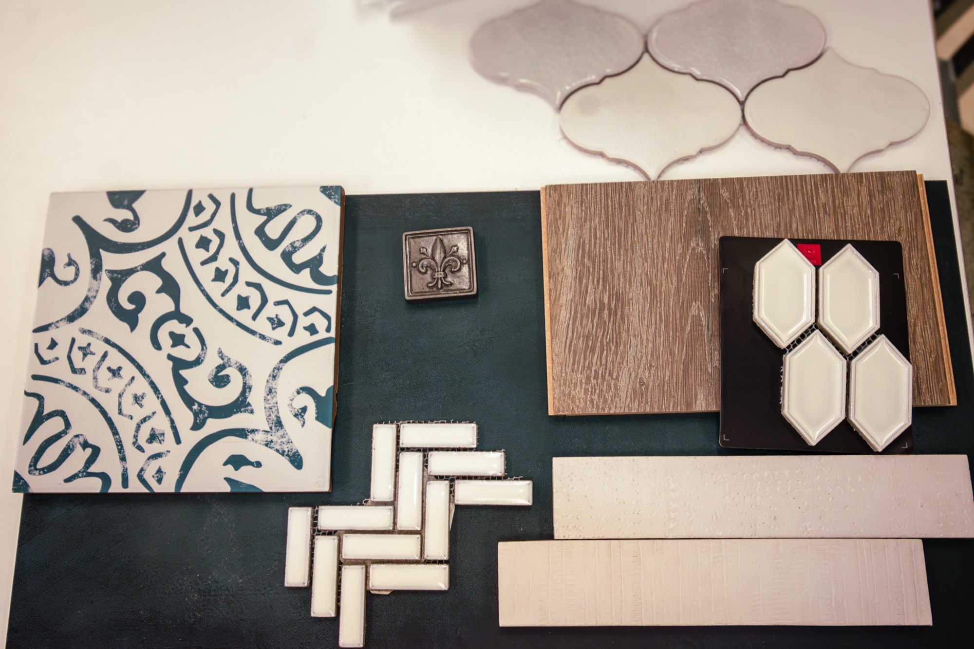 Tile and flooring samples laid out on a design table