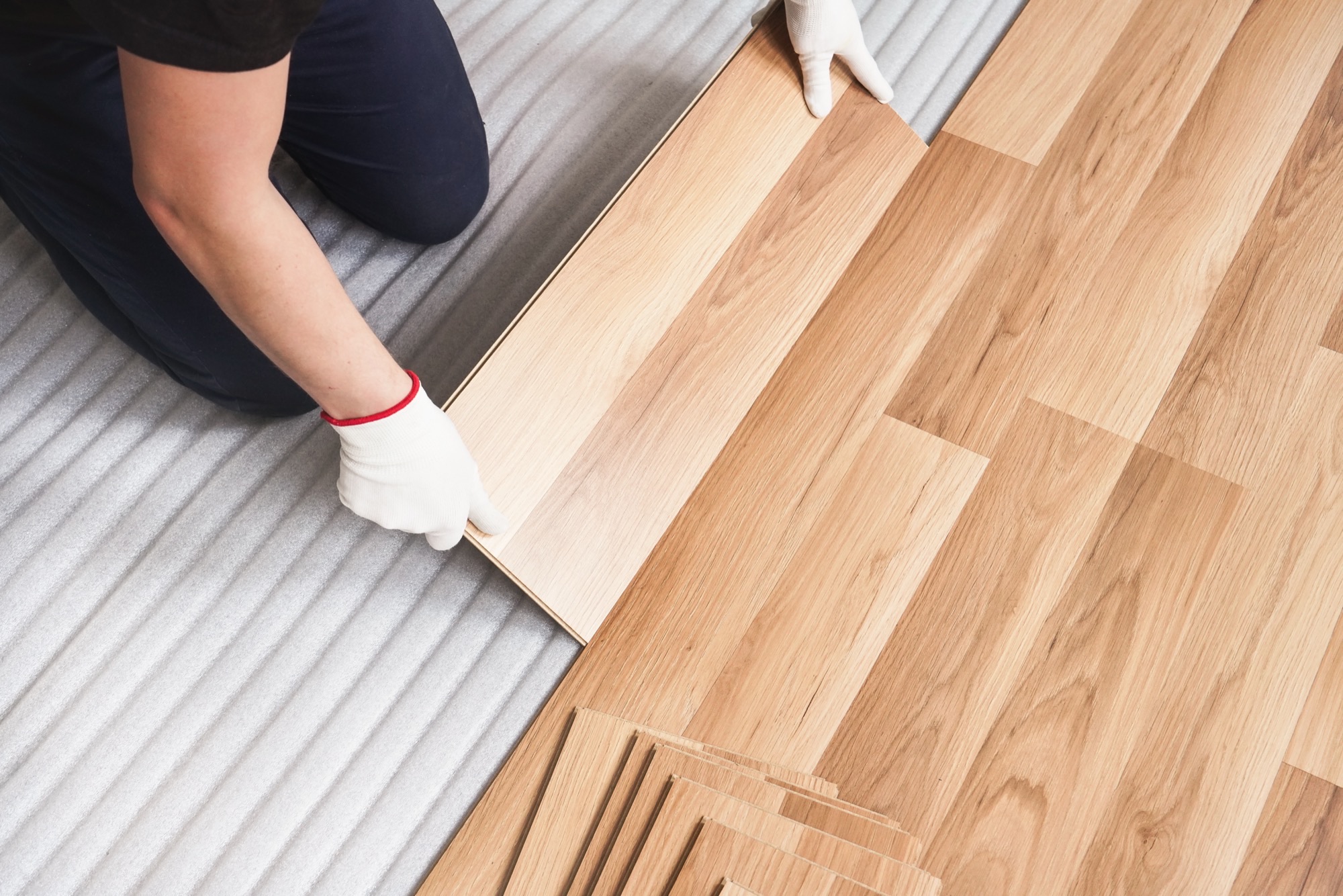 Wood-look planks being clicked into place