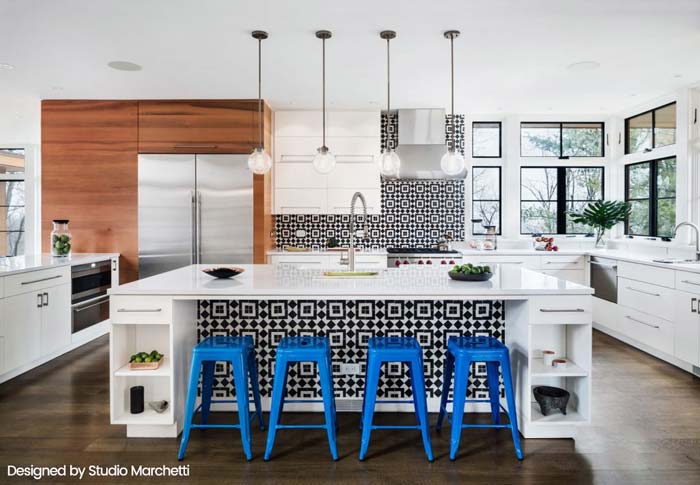 Modern kitchen with blue bar stools and geometric tile backsplash